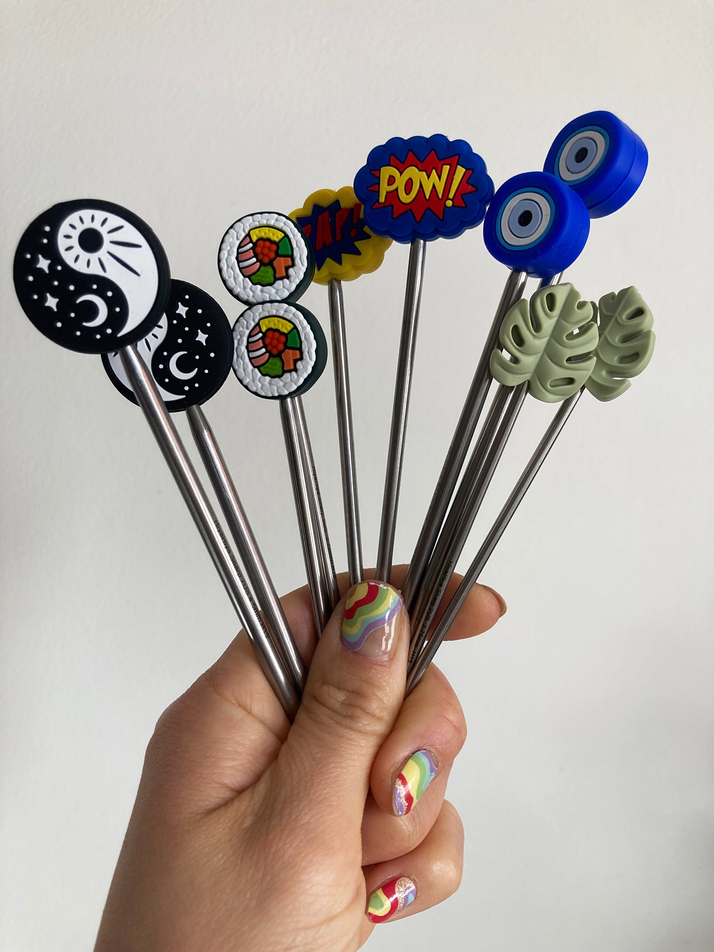 A group of knitting needle protectors in modern  fun designs